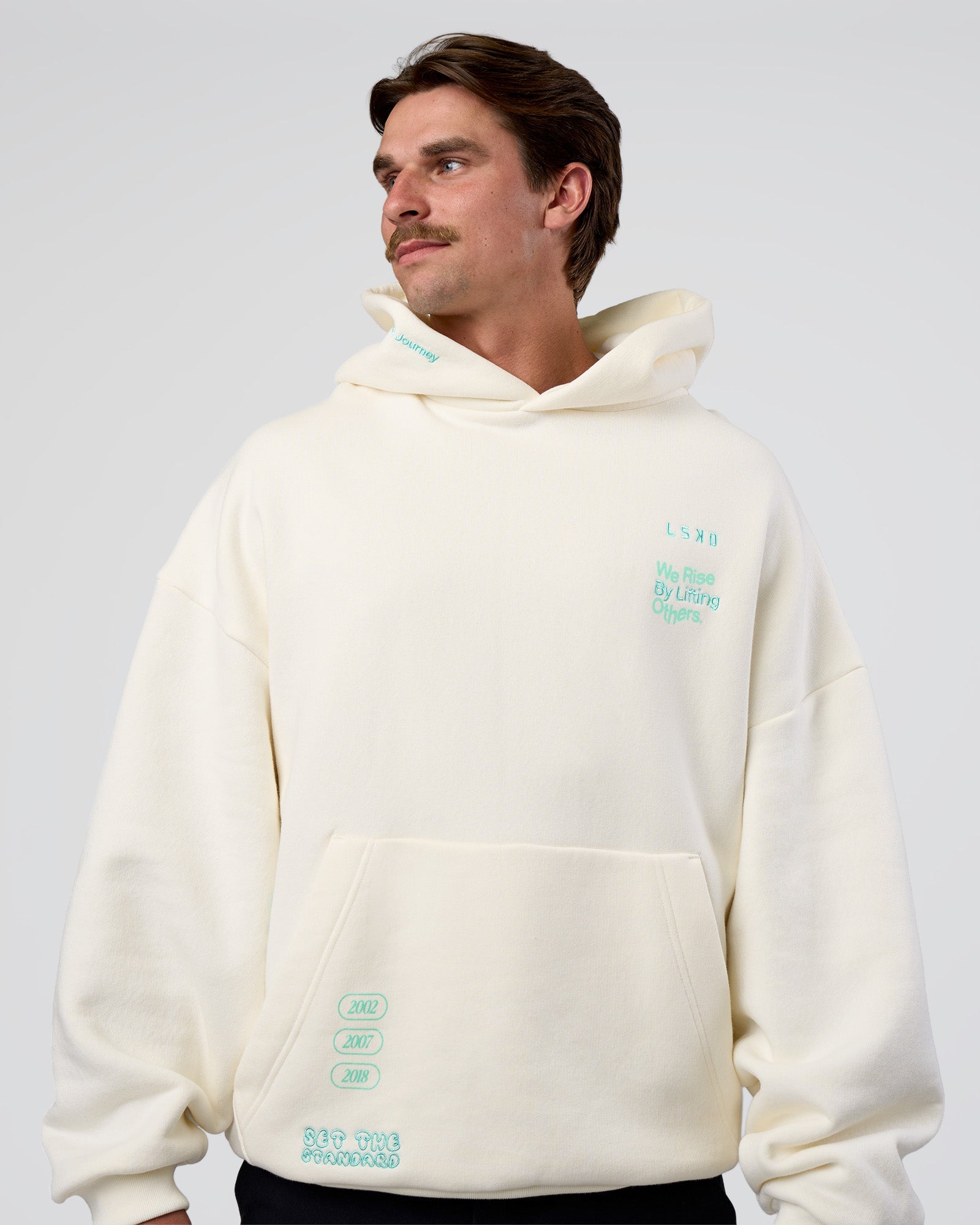 Man wearing Sticker Unisex Oversized Hoodie - Off White-Jelly Mint | Model:Konnor | Size:M