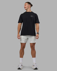 Man wearing Today's Run FLXCotton Oversized Tee - Black-White | Model:Jaiden | Size:M