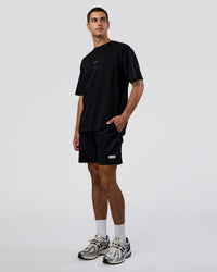 Man wearing Together We Rise FLXCotton Oversized Tee - Black-Candy Pink | Model:Zoran | Size:M