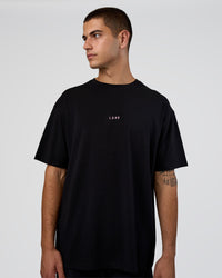Man wearing Together We Rise FLXCotton Oversized Tee - Black-Candy Pink | Model:Zoran | Size:M