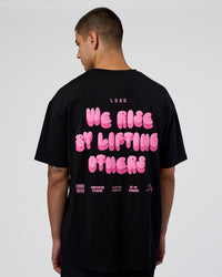 Man wearing Together We Rise FLXCotton Oversized Tee - Black-Candy Pink | Model:Zoran | Size:M