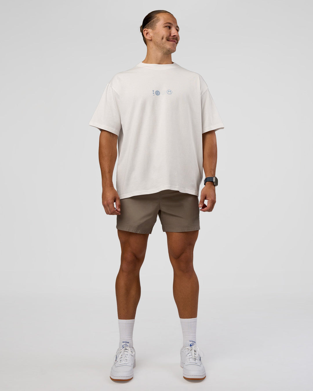 Man wearing Trust The Process Heavyweight Unisex Oversized Tee - Off White-Electric Indigo | Model:Jaiden | Size:M
