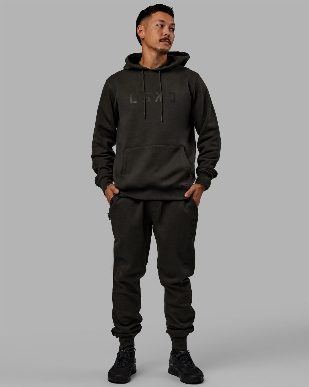 Man wearing Unisex Structure Hoodie - Pirate Black-Black