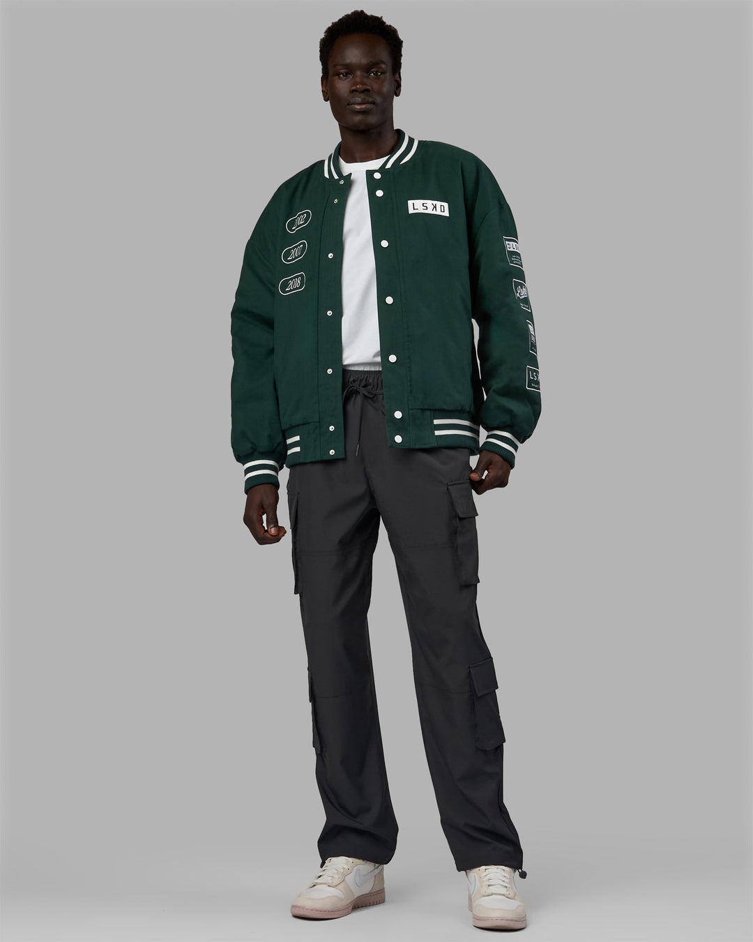 Man wearing Unisex Timeline Jacket - Vital Green-White