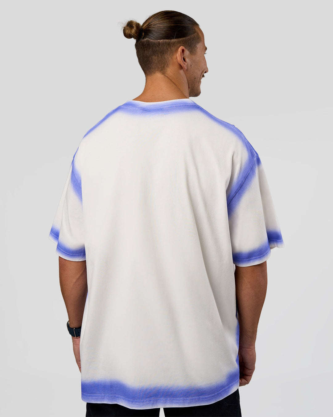 Man wearing Urban Blur Heavyweight Unisex Oversized Tee - Off White-Power Cobalt | Model:Jaiden | Size:M