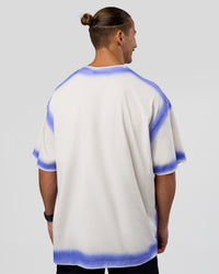Man wearing Urban Blur Heavyweight Unisex Oversized Tee - Off White-Power Cobalt | Model:Jaiden | Size:M