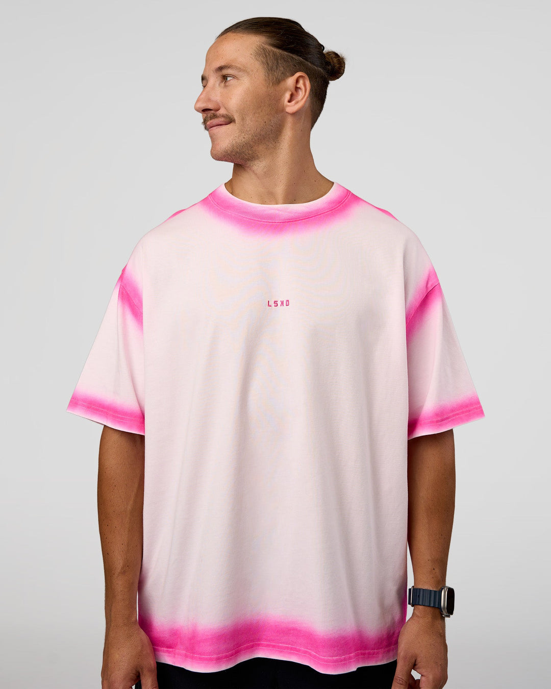 Man wearing Urban Blur Heavyweight Unisex Oversized Tee - Off White-Ultra Pink | Model:Jaiden | Size:M