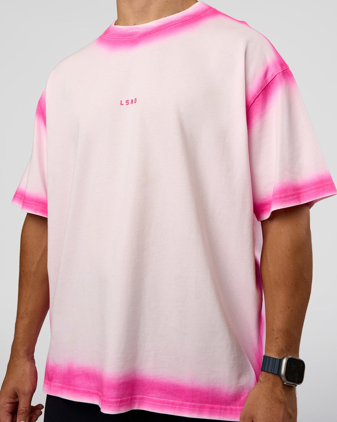 Man wearing Urban Blur Heavyweight Unisex Oversized Tee - Off White-Ultra Pink | Model:Jaiden | Size:M