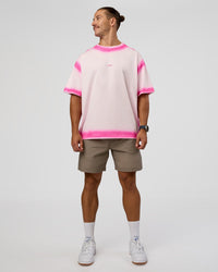 Man wearing Urban Blur Heavyweight Unisex Oversized Tee - Off White-Ultra Pink | Model:Jaiden | Size:M