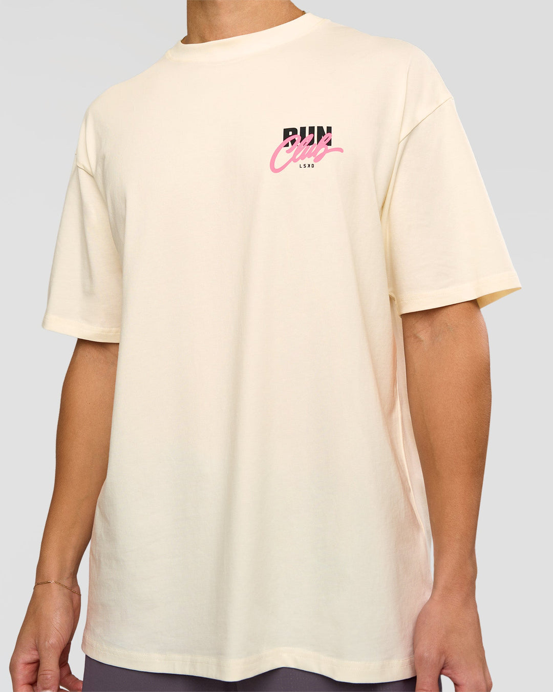Man wearing Values Run Club FLXCotton Tee - Off White-Candy Pink | Model:Leandro | Size:M