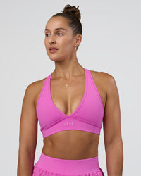 Woman wearing Stamina Sports Bra - Ultra Fuchsia | Set:true | Angle:front | Model:Abbey | Size:M
