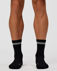 Man wearing Run Club Fast Performance Socks 2.0 - Black-Reflective