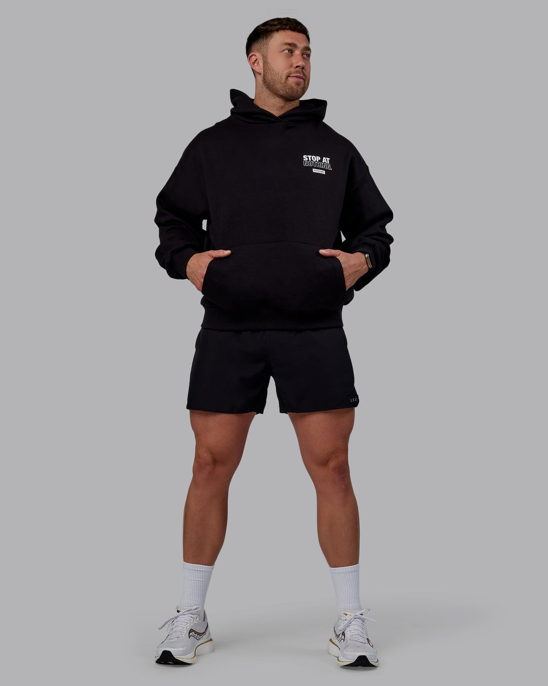 Man wearing Unisex Fitstop Stop at Nothing Hoodie Oversize - Black