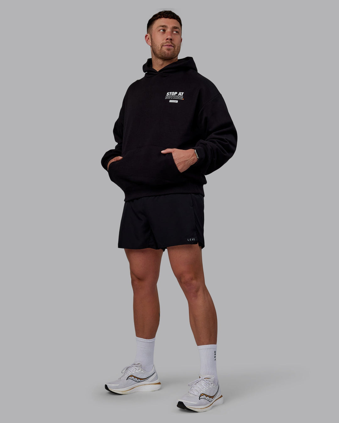 Man wearing Unisex Fitstop Stop at Nothing Hoodie Oversize - Black