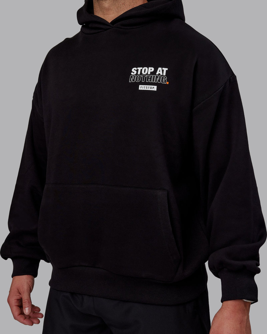 Man wearing Unisex Fitstop Stop at Nothing Hoodie Oversize - Black