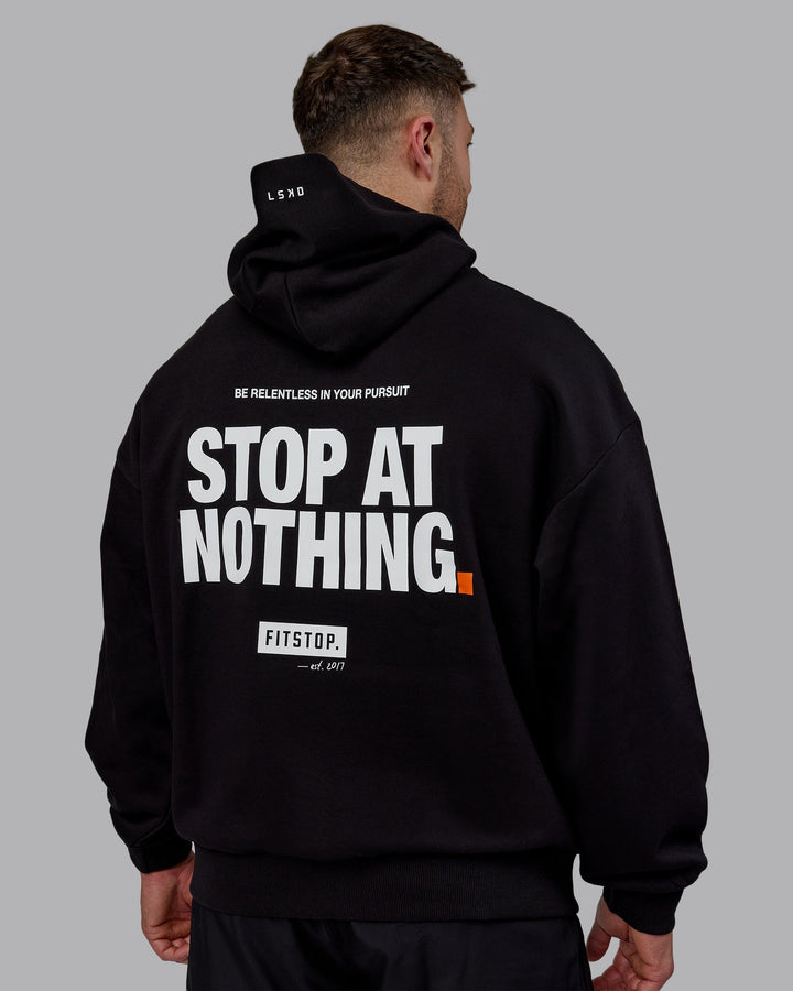 Man wearing Unisex Fitstop Stop at Nothing Hoodie Oversize - Black
