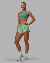 Woman wearing Accelerate 3" Run Shorts - Surreal Green