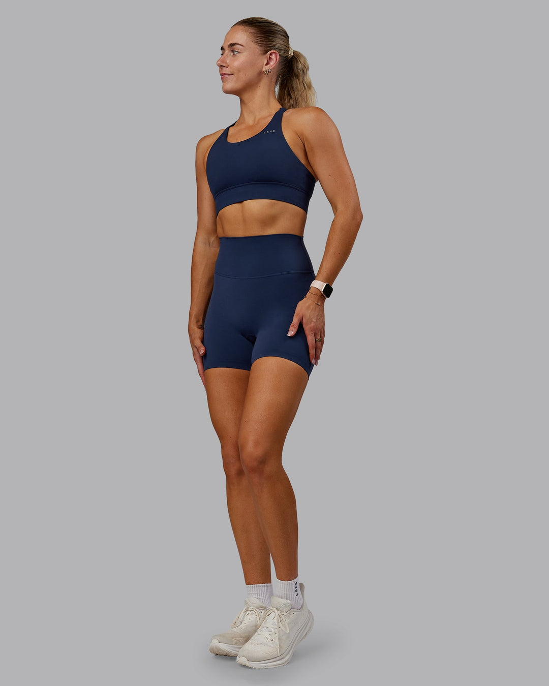 Woman wearing Accelerate Sports Bra - Future Navy