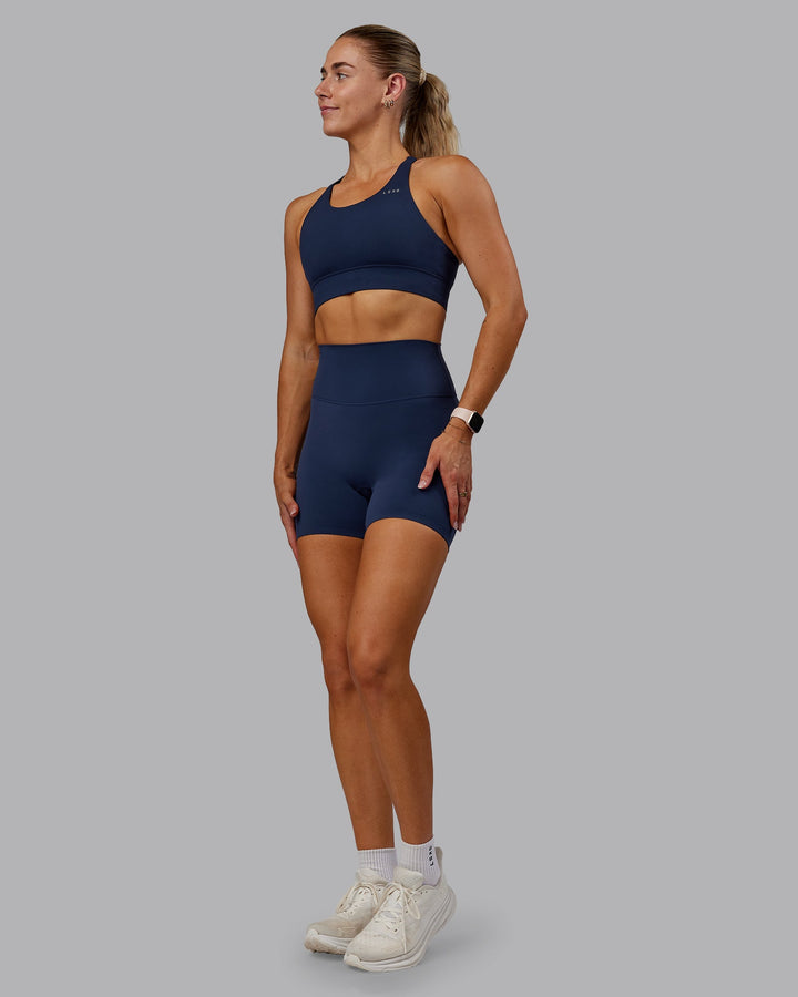 Woman wearing Accelerate Sports Bra - Future Navy
