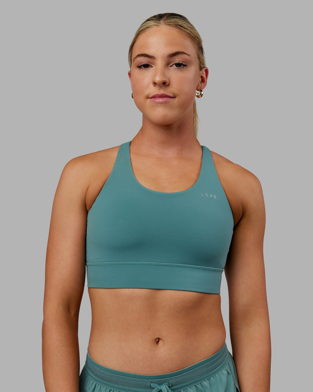 Woman wearing Accelerate Sports Bra - Sagebrush