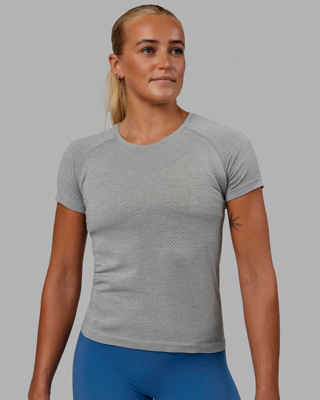 Woman wearing AeroFLX+ Seamless Tee - Light Grey Marl