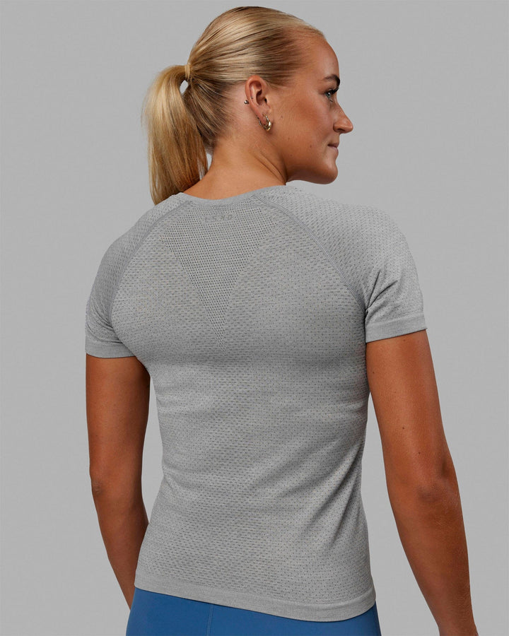 Woman wearing AeroFLX+ Seamless Tee - Light Grey Marl
