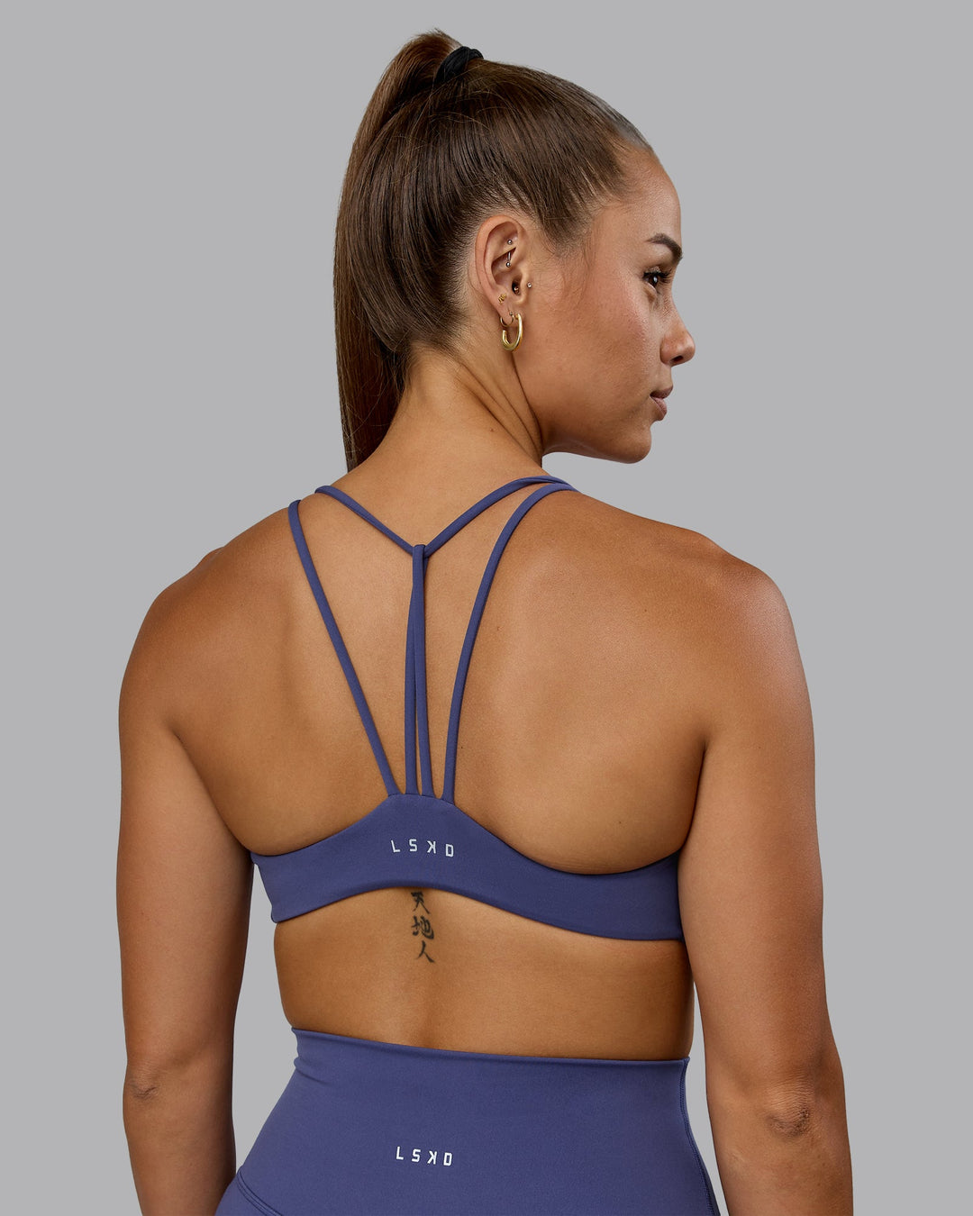 Woman wearing Agile Sports Bra - Future Dusk