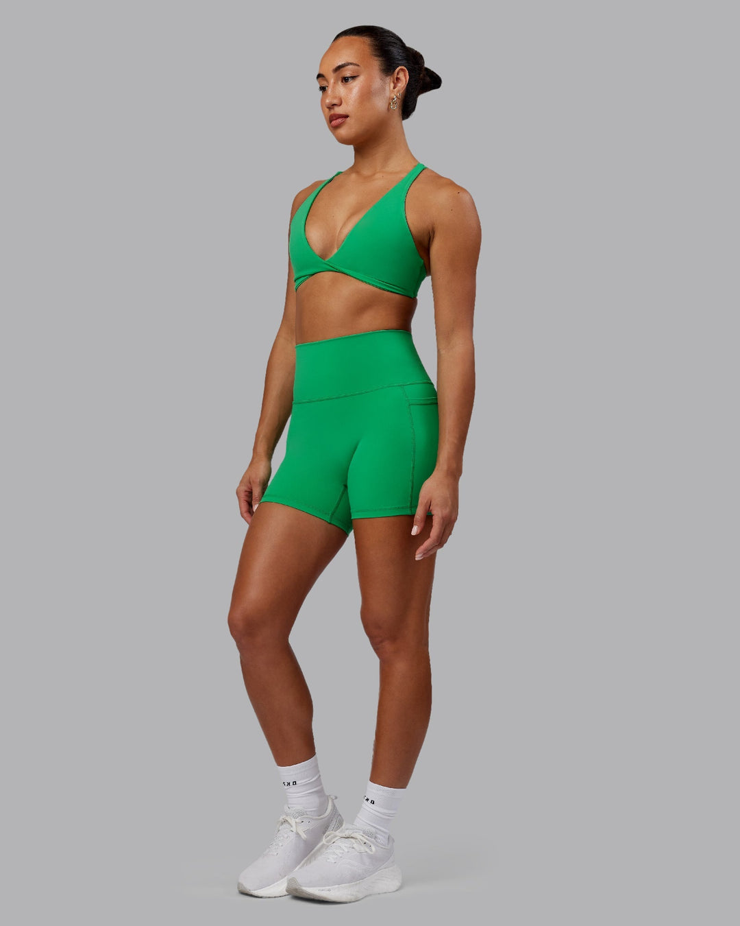 Woman wearing Agile Sports Bra - Impact Green