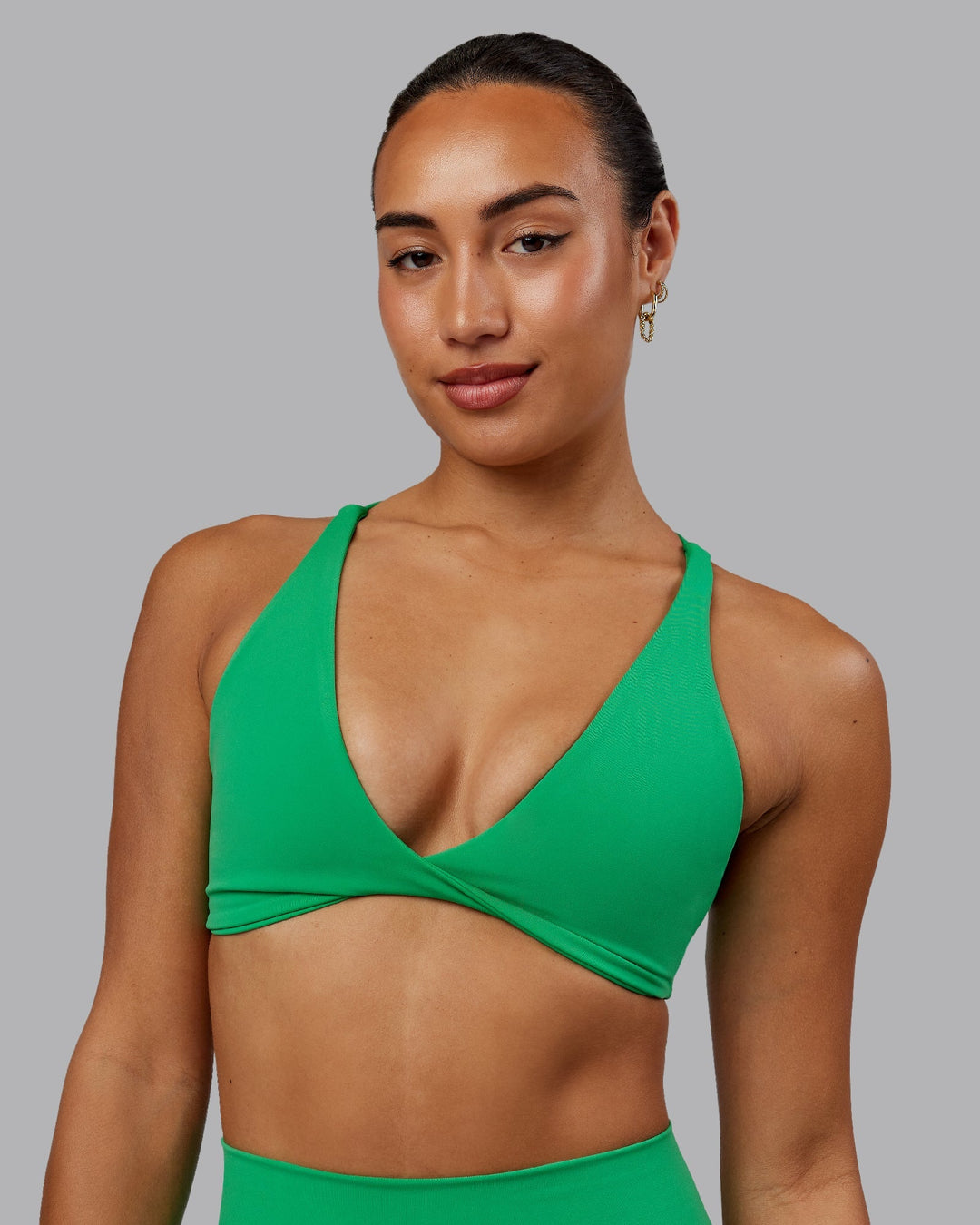 Woman wearing Agile Sports Bra - Impact Green