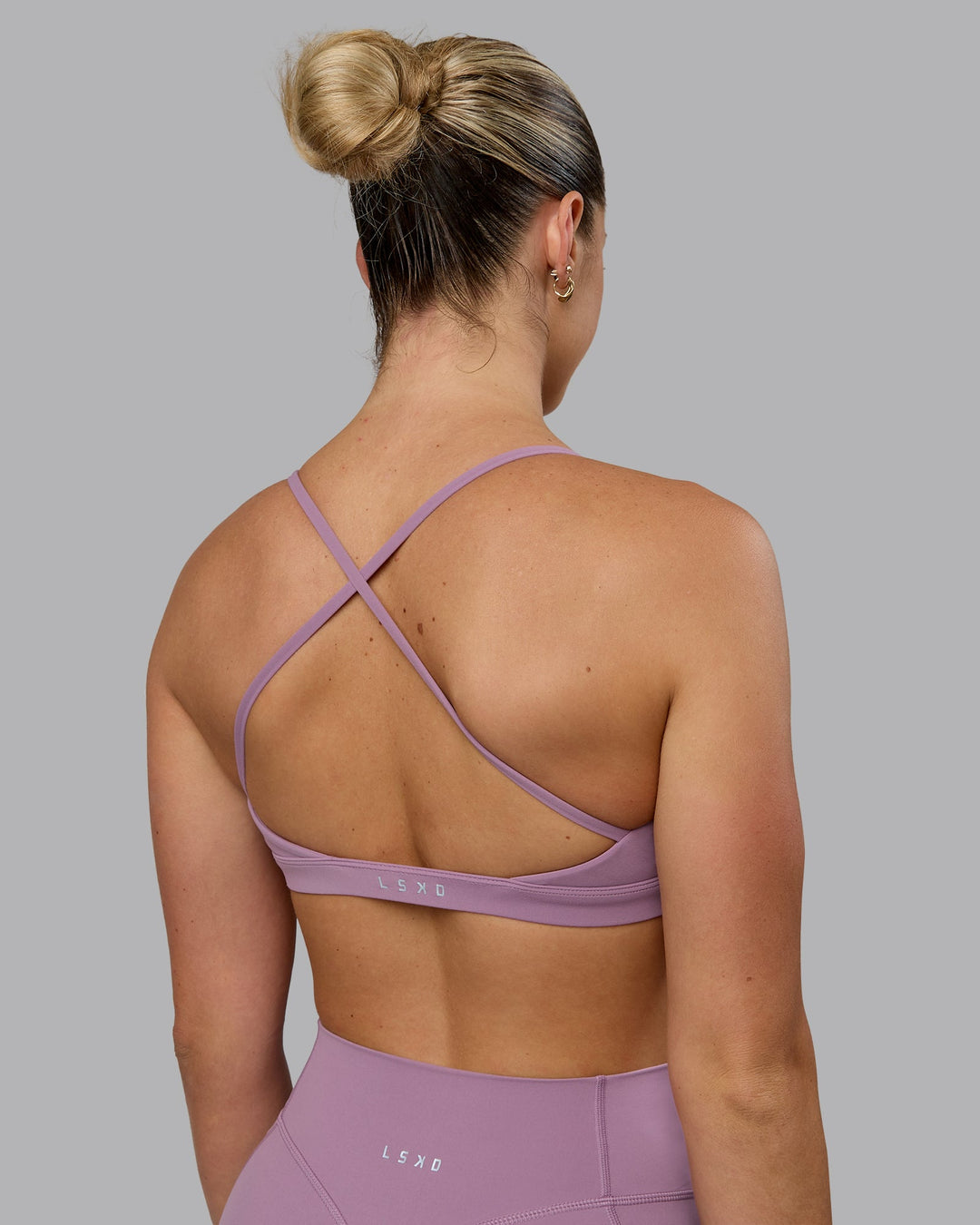 Woman wearing Ascend Sports Bra - Grape