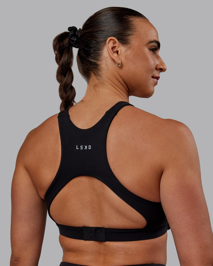 Woman wearing Ascent Sports Bra - Black
