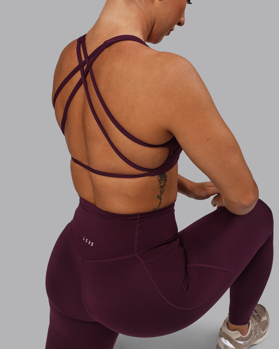 Woman wearing Aspire Sports Bra - Cherry Lacquer