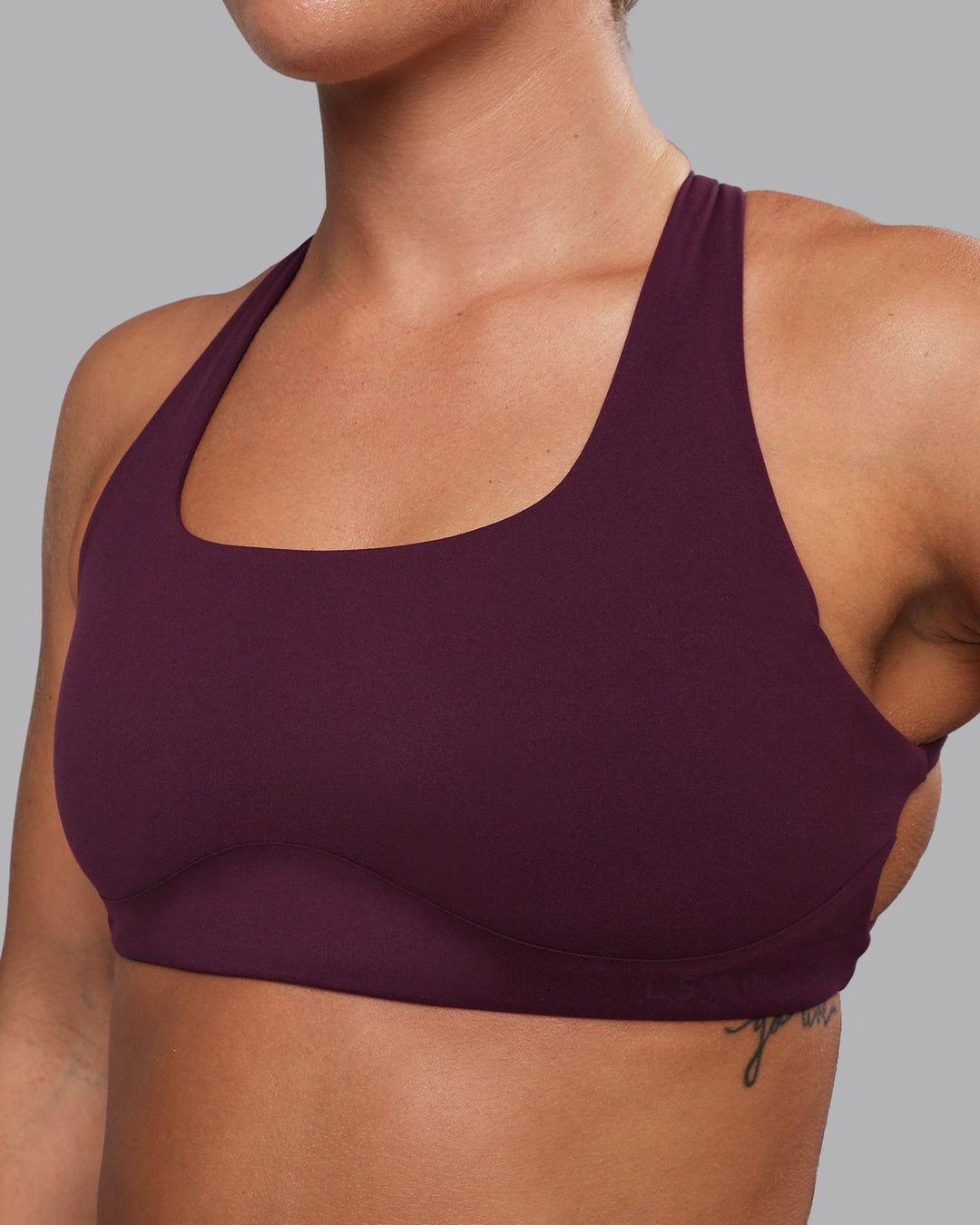 Woman wearing Aspire Sports Bra - Cherry Lacquer