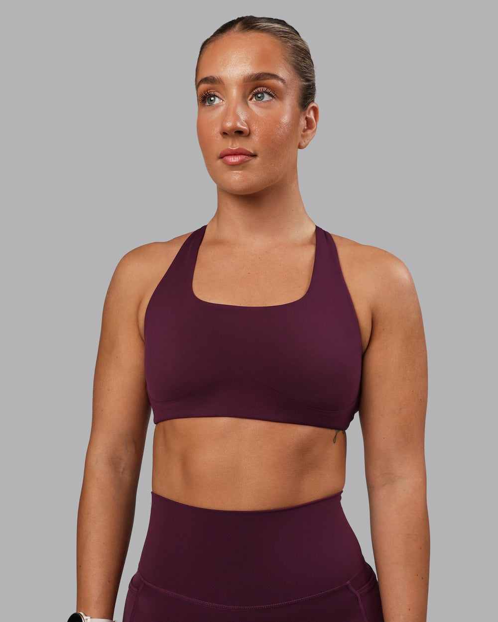 Woman wearing Aspire Sports Bra - Cherry Lacquer