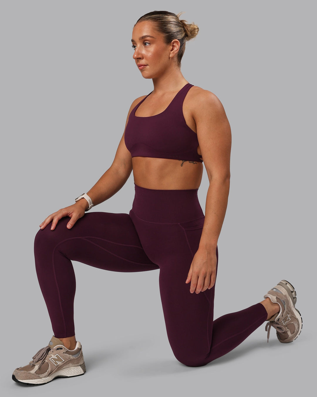 Woman wearing Aspire Sports Bra - Cherry Lacquer