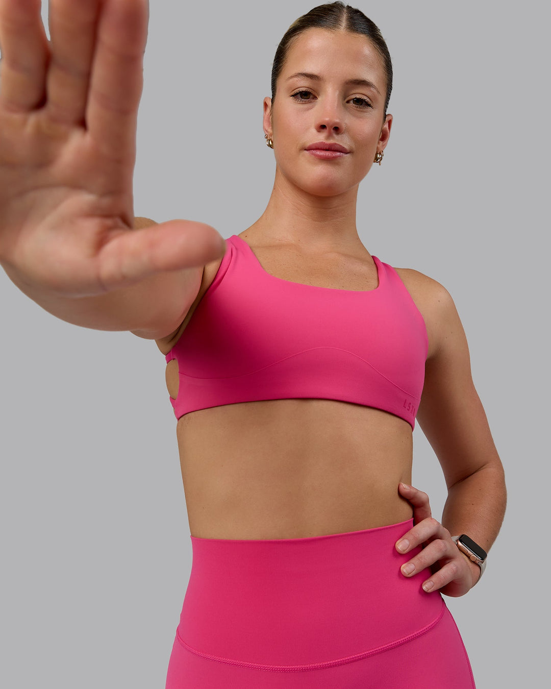 Woman wearing Aspire Sports Bra - Pink Flash