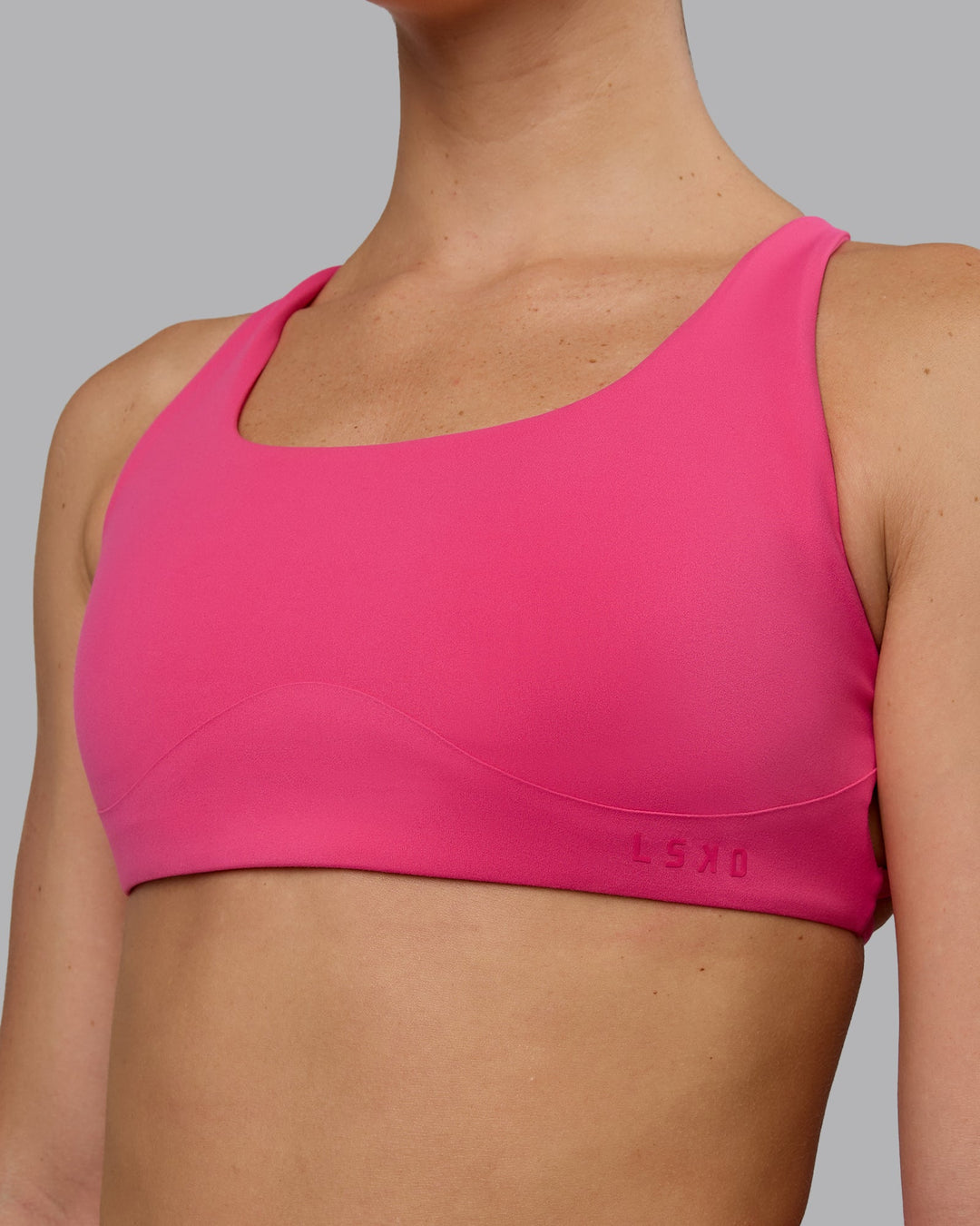 Woman wearing Aspire Sports Bra - Pink Flash