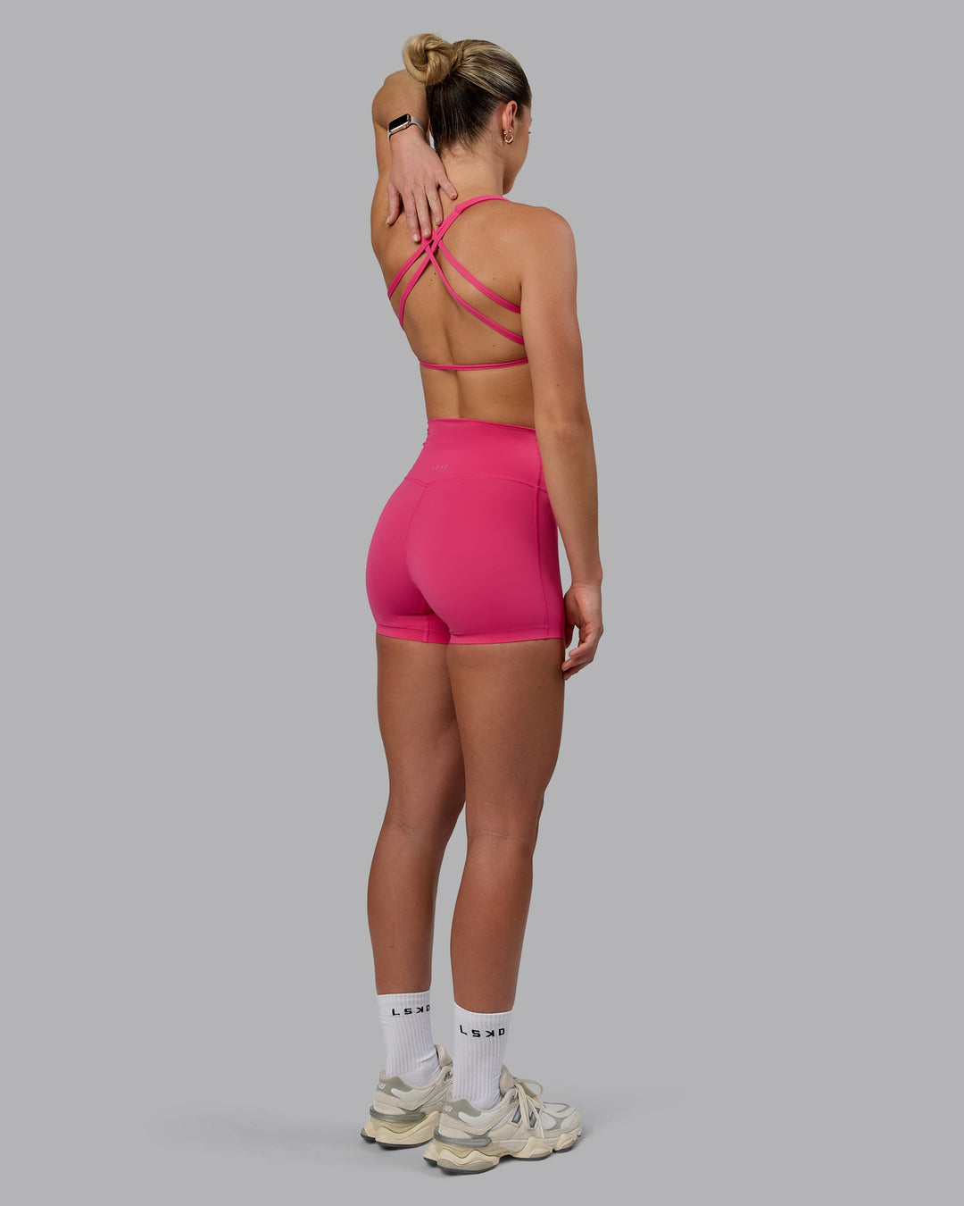 Woman wearing Aspire Sports Bra - Pink Flash