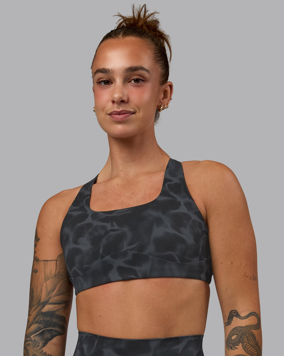 Woman wearing Aspire Sports Bra - Tranquil-Black