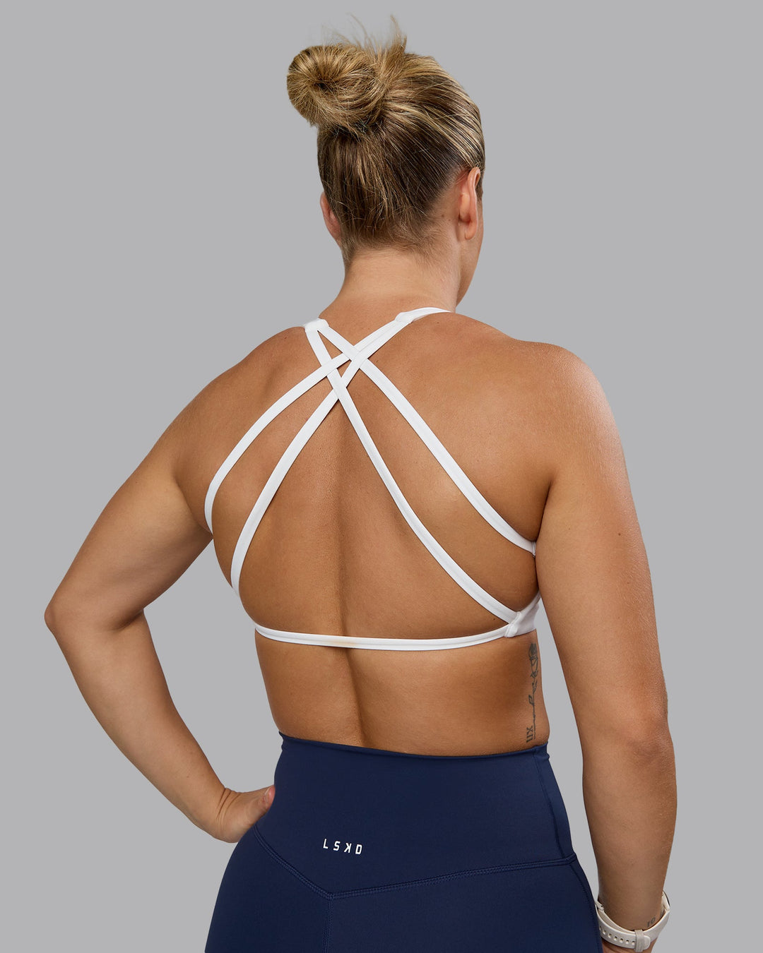 Woman wearing Aspire Sports Bra - White