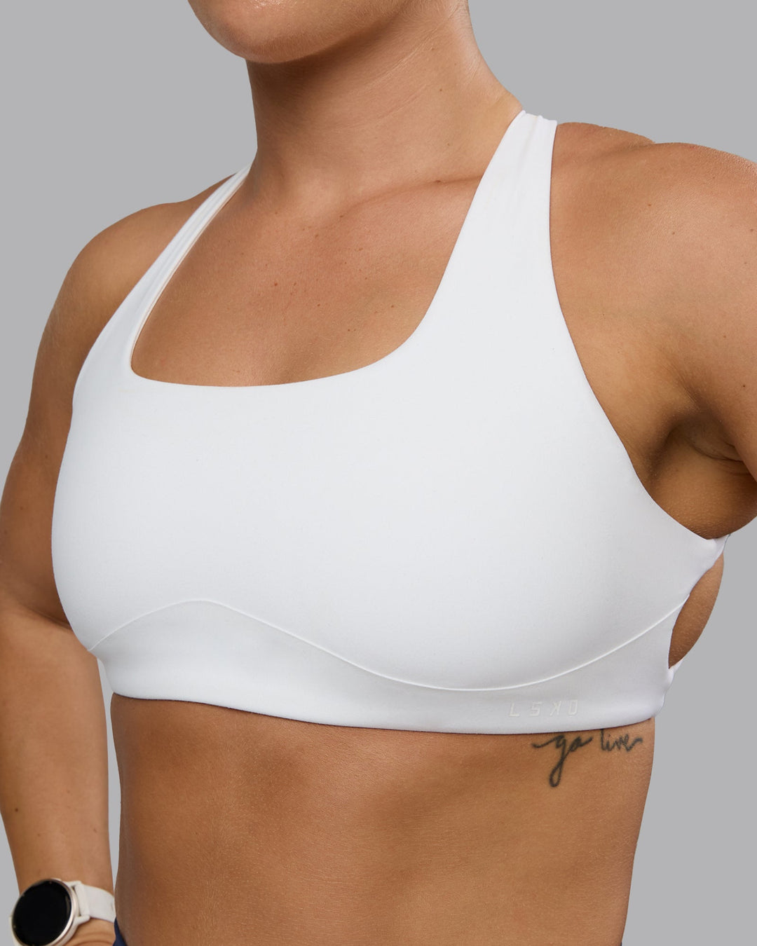 Woman wearing Aspire Sports Bra - White