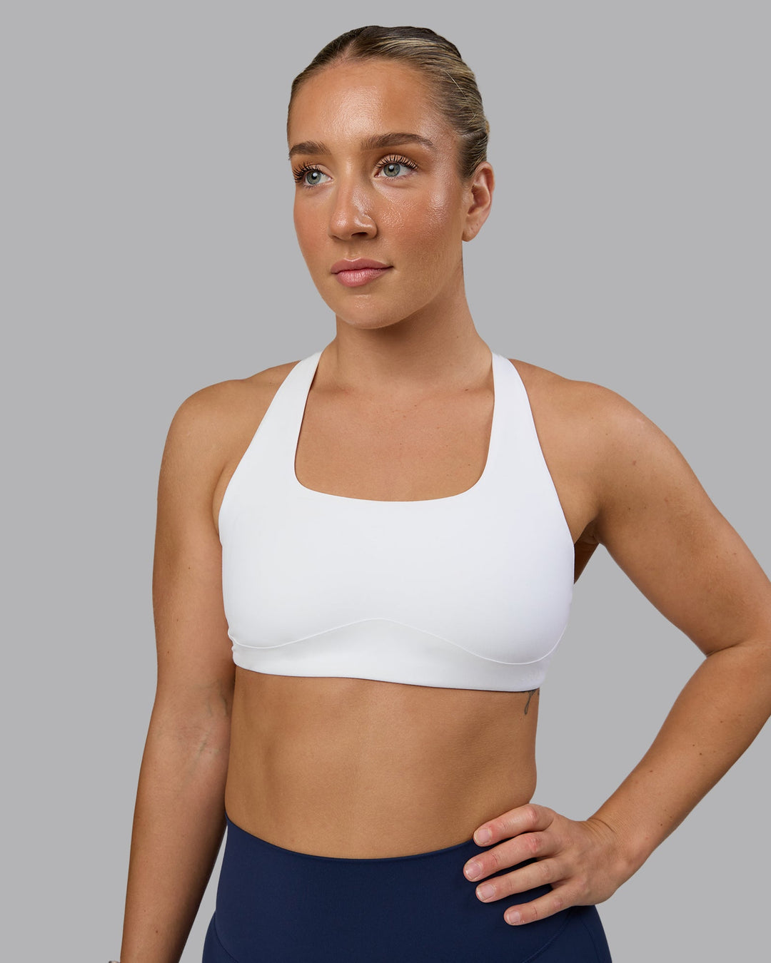 Woman wearing Aspire Sports Bra - White