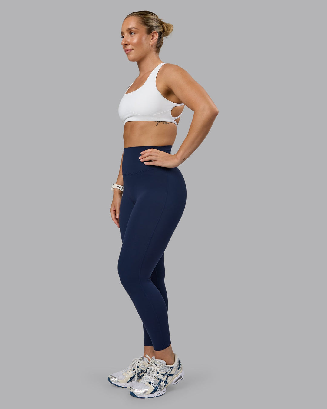 Woman wearing Aspire Sports Bra - White