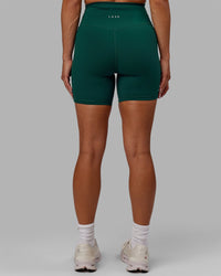 Woman wearing Base 2.0 Ultra High-Rise 6" Short - Dark Moss