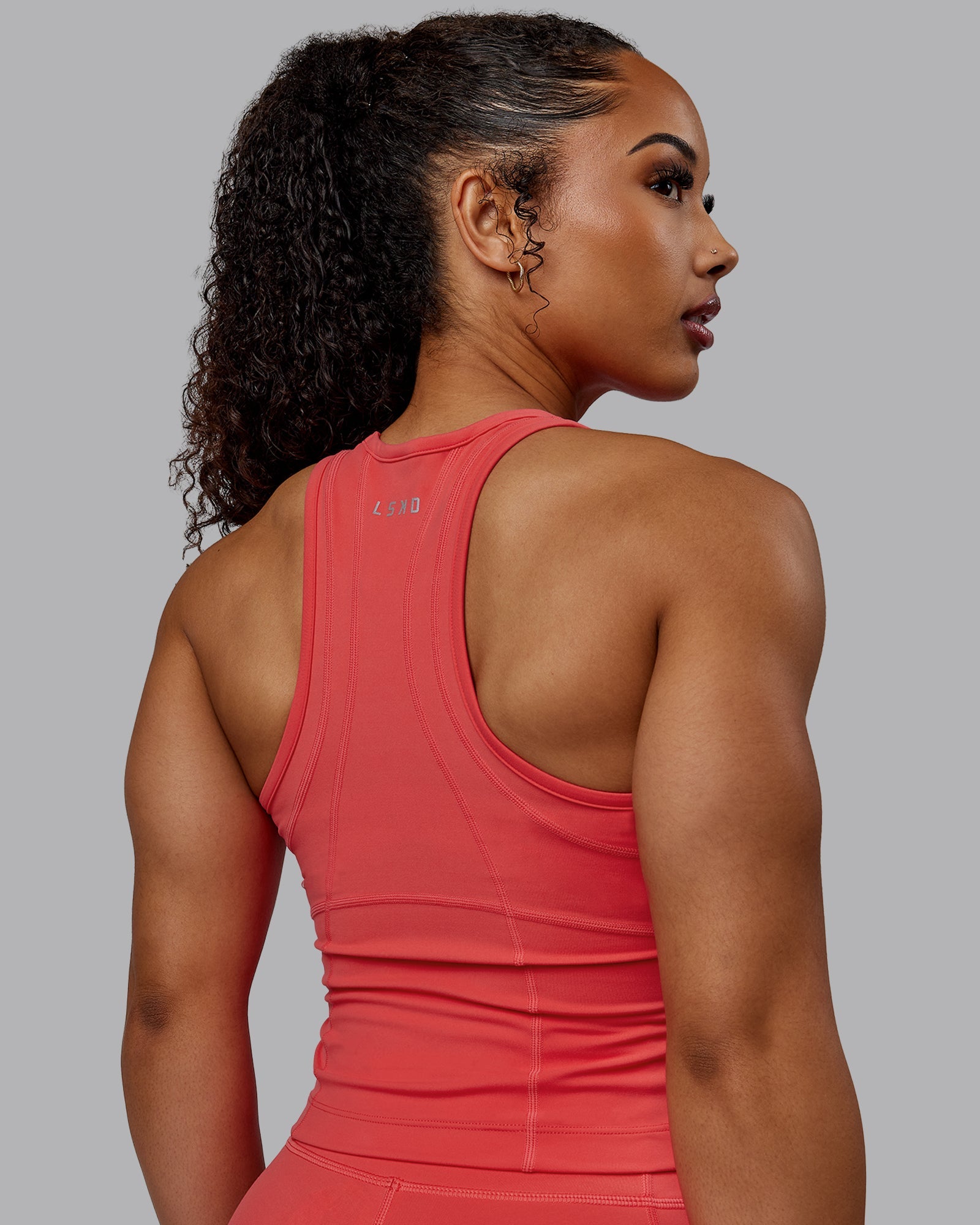 Woman wearing Bend Performance Tank - Cayenne