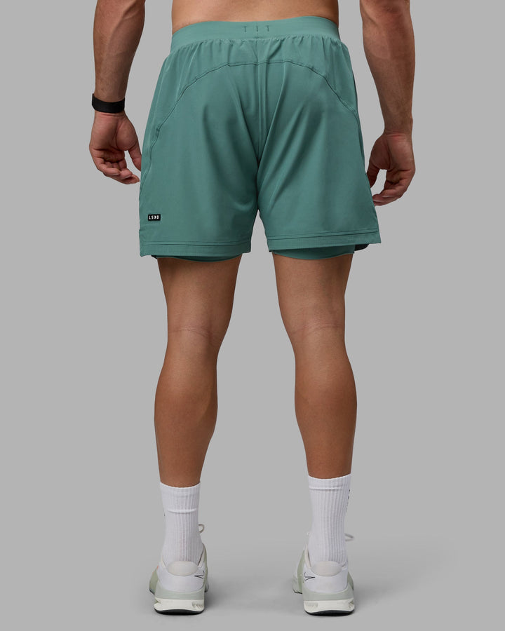 Man wearing Challenger 6&quot; Lined Performance Shorts - Sagebrush
