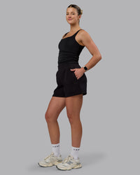 Woman wearing Elevate SoftTouch 4" Shorts - Black-Black