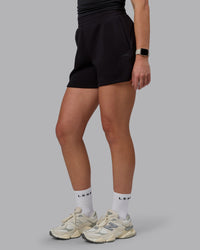 Woman wearing Elevate SoftTouch 4" Shorts - Black-Black