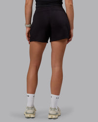 Woman wearing Elevate SoftTouch 4" Shorts - Black-Black