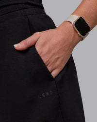 Woman wearing Elevate SoftTouch 4" Shorts - Black-Black
